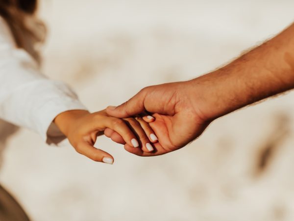 Lovely couple holding hands on white background. Couple together